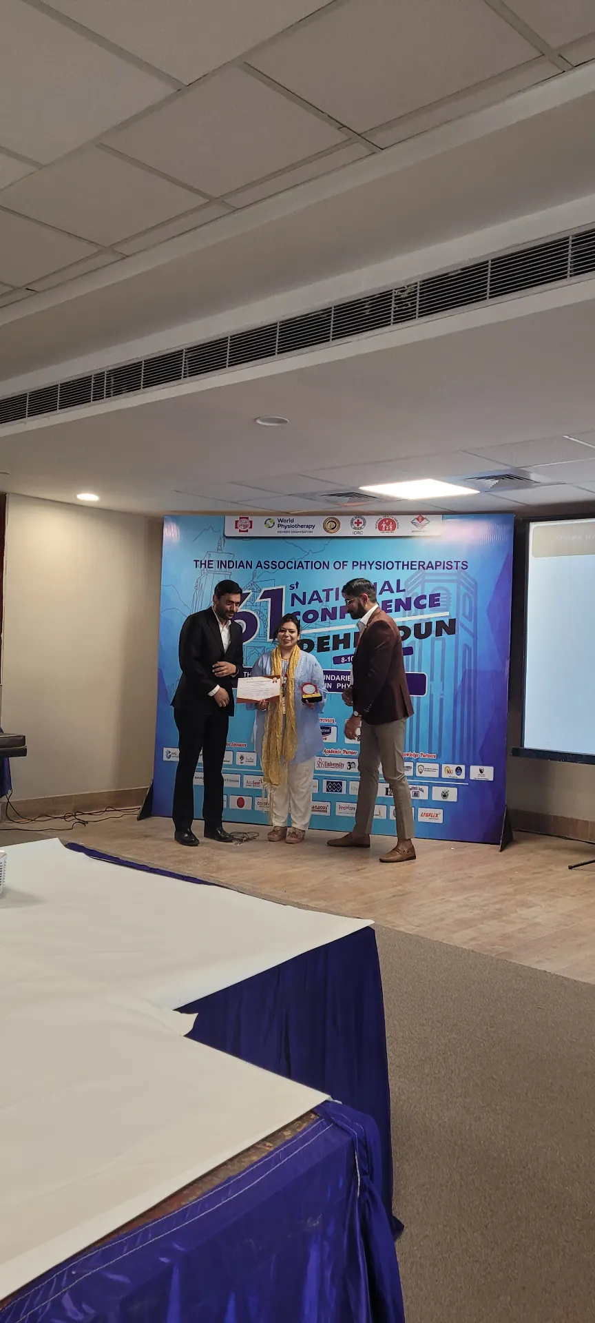 Receiving an award on stage at the Indian Association of Physiotherapists 61st National Conference